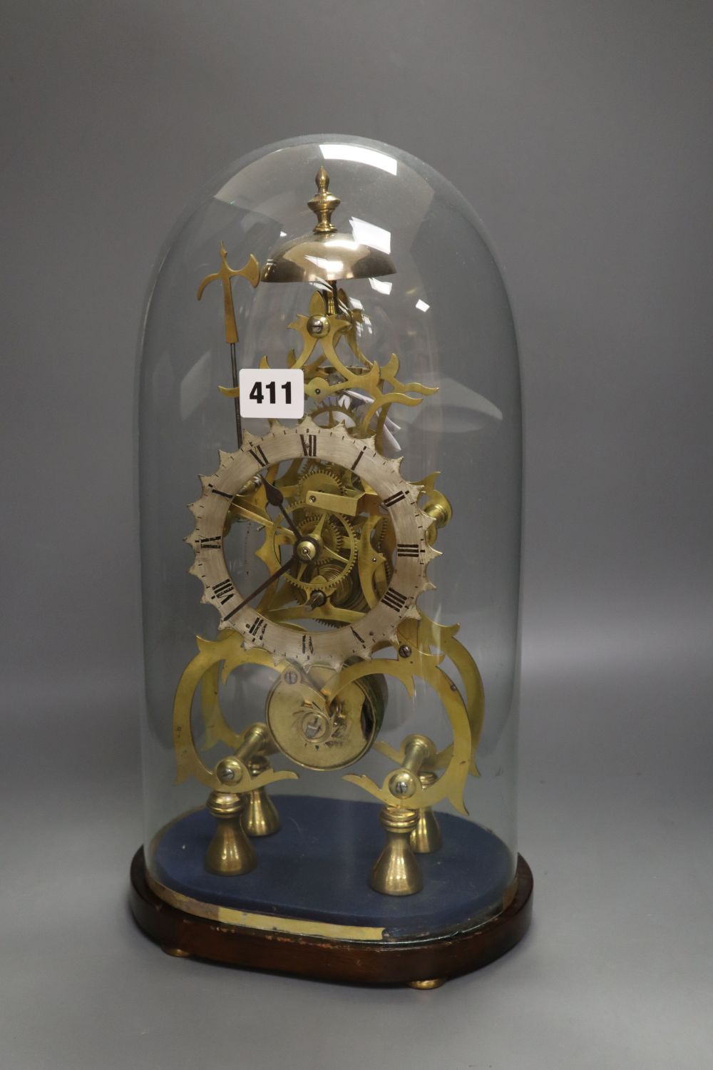 A 19th century brass skeleton clock, with fusee and in-line train, under glass dome, with key and pendulum, height 41cm